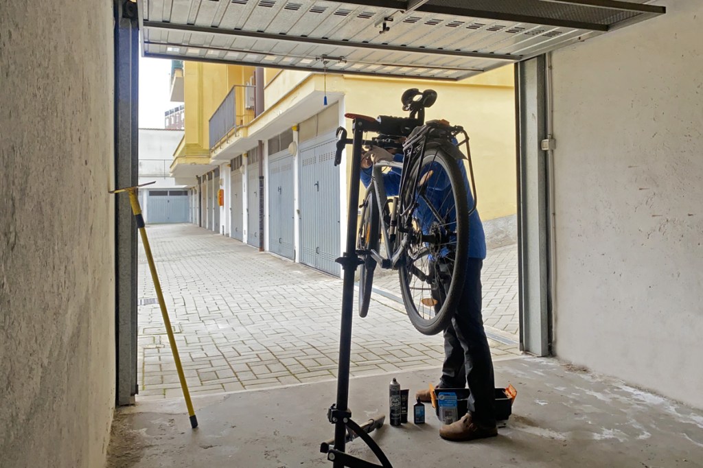 una bicicletta, un ragazzo, l'interno di una rimessa per autoveicoli