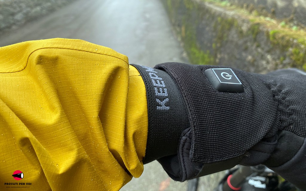 primo piano su una giacca impermeabile infilata all'interno di un guanto allo scopo di proteggere il ciclista dal freddo, dalla pioggia e dall'umidità tipici di una giornata invernale