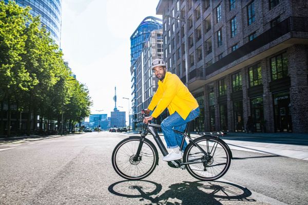 Ciclista urbano in città durante uno spostamento quotidiano in bicicletta
